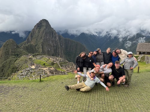 A group of travellers posing at Machu Picchu