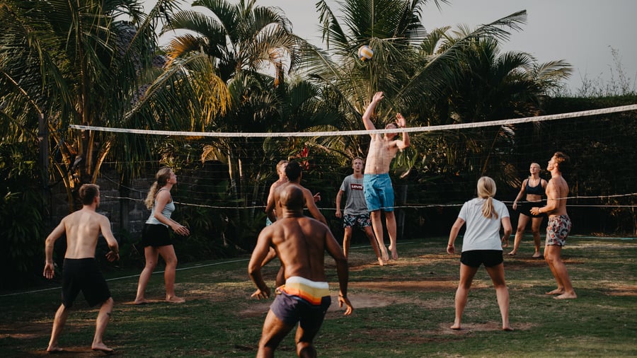Group of new friends playing volleyball in Bali