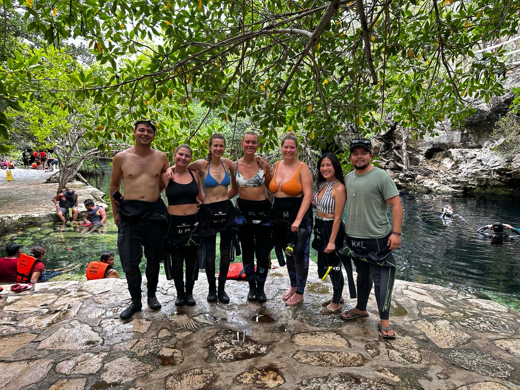 Group of travellers by a cenote in Mexico