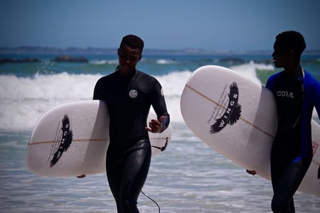 Two people with surf boards in South Africa
