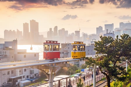 Små spårvagnar rullar längs kusten i Busan