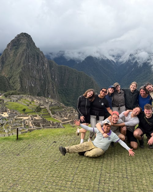 A group of travellers posing at Machu Picchu