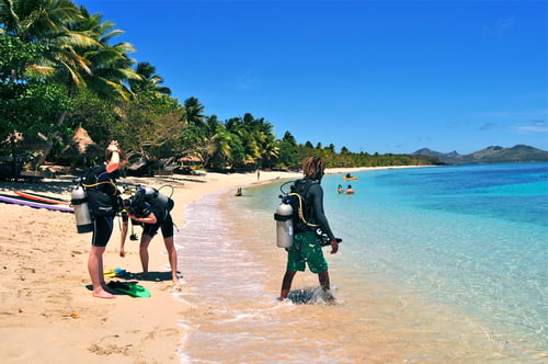 Divers on the beach in Fiji