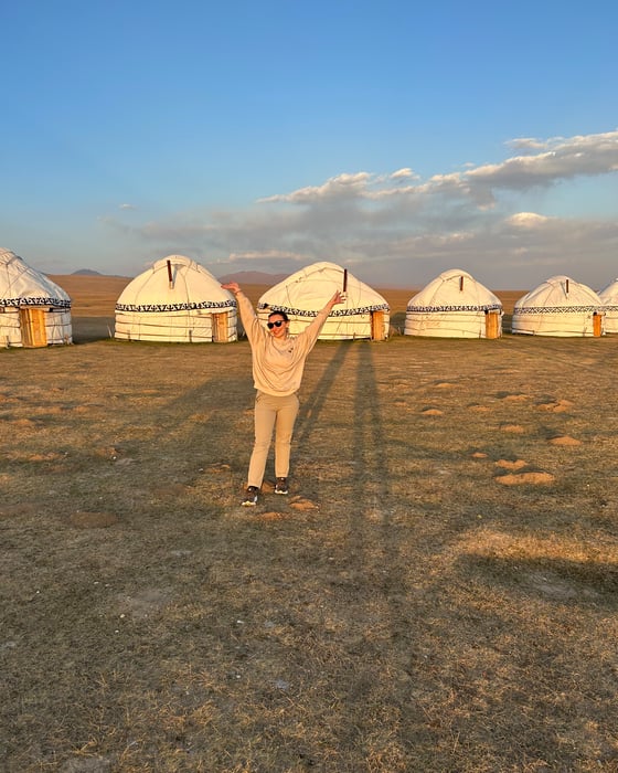 Traveller in front of traditional yurts 