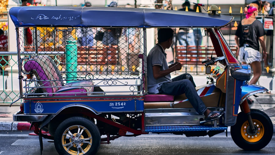 Man driving a tuk tuk in Bangkok