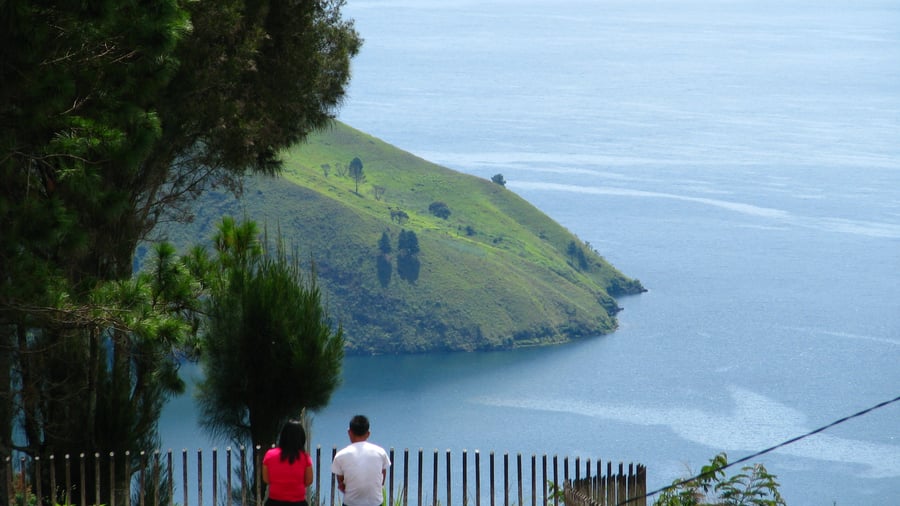 Two people taking in the view at Lake Toba