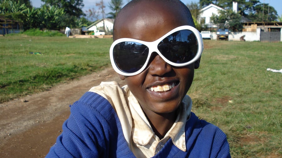 Boy wearing sunglasses in Africa
