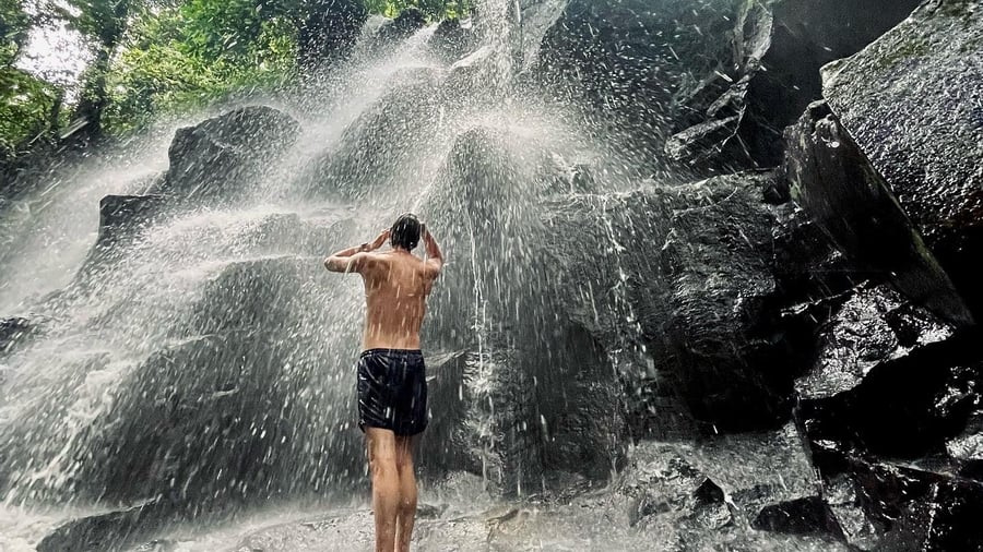 Man in front of waterfall in Ubud