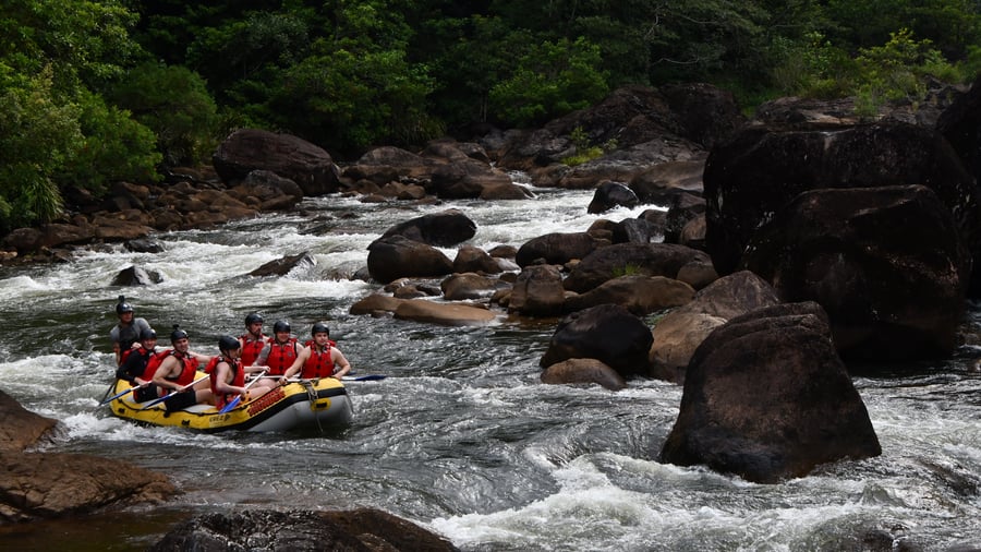 Group of people river rafting