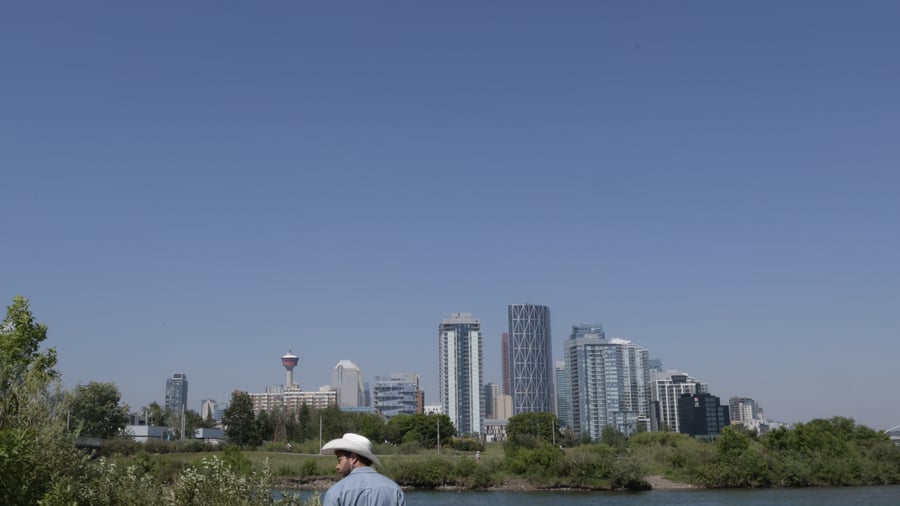 Person walking along water in Western Canada
